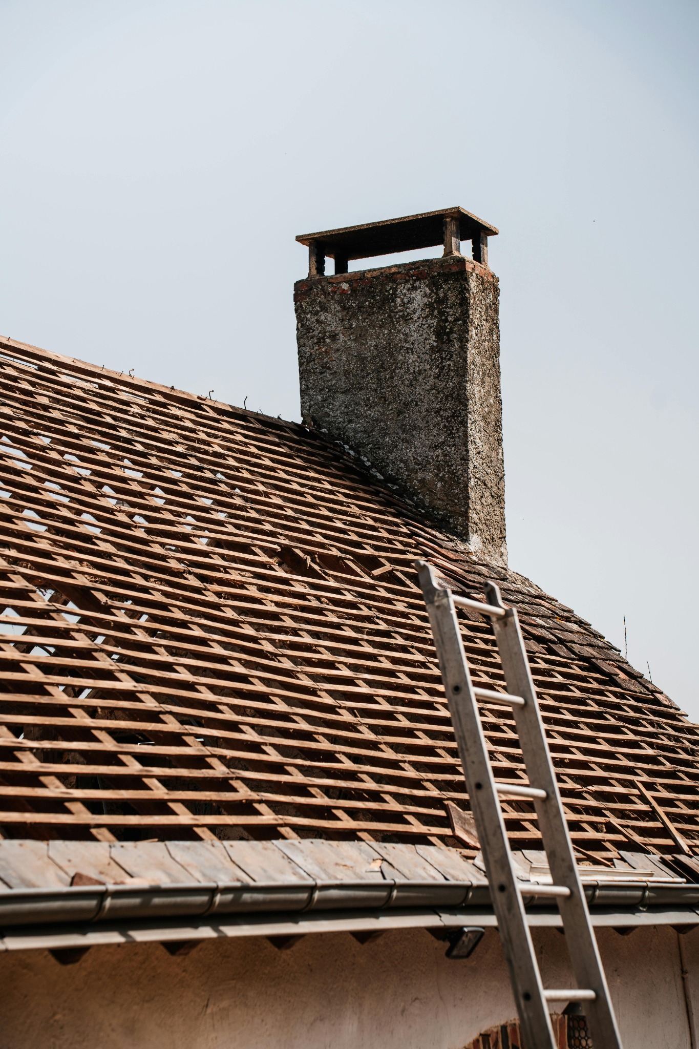 Roof repair near chimney and ladder