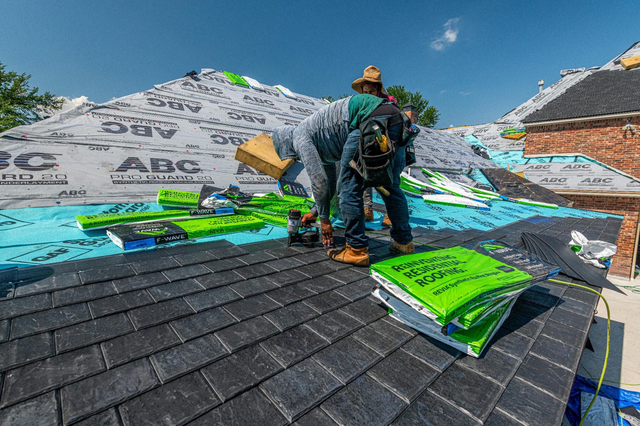 Roofer installing shingles