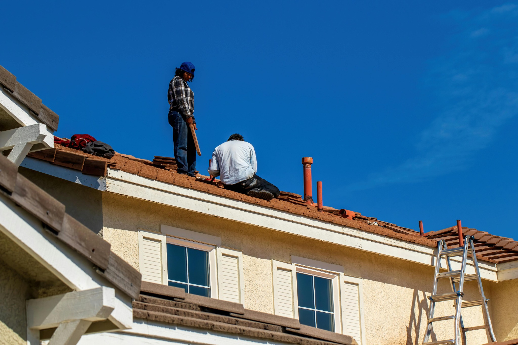 Roofers working on residential roof replacement